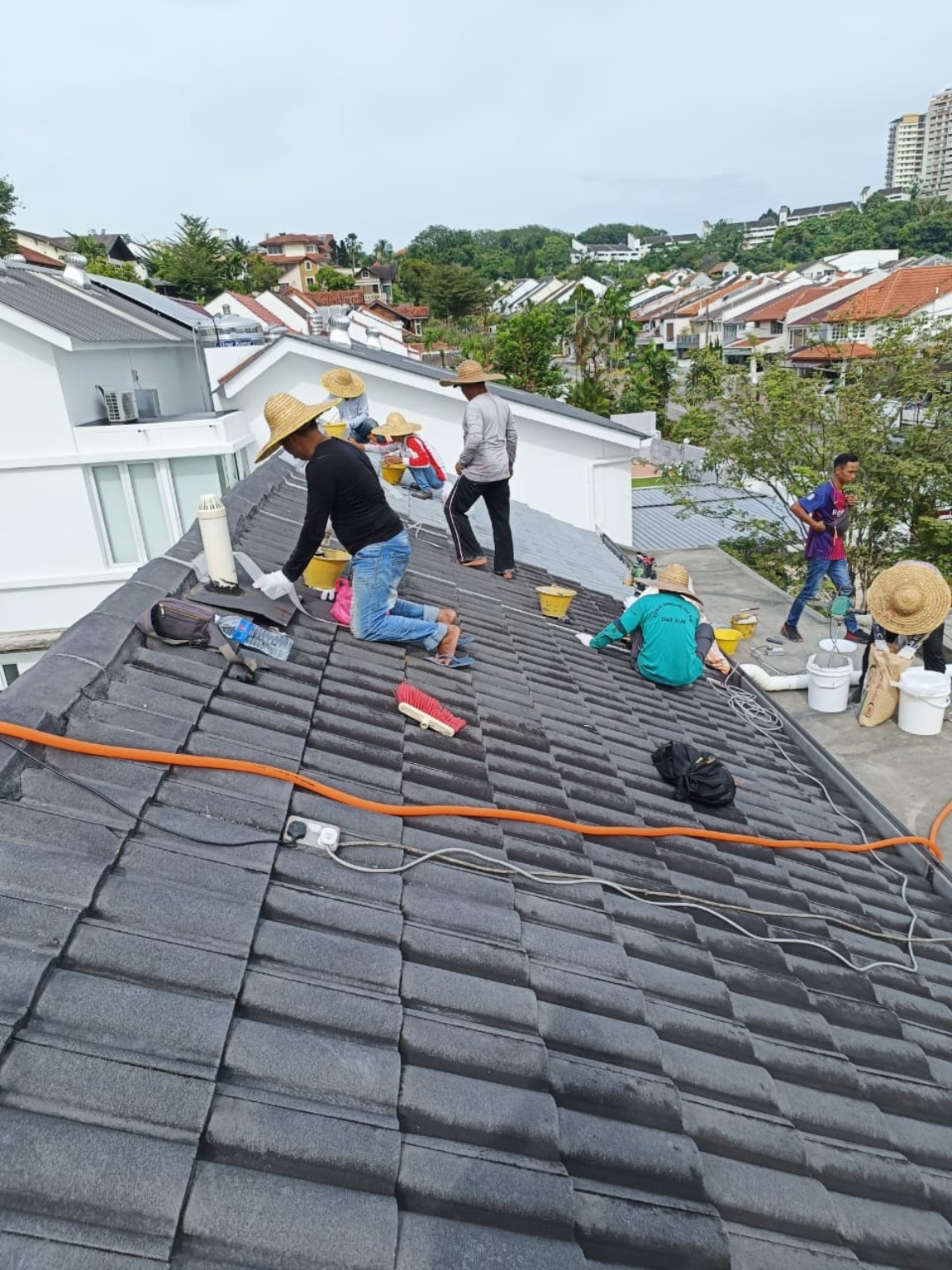 Residential tiled roof waterproofing team at work